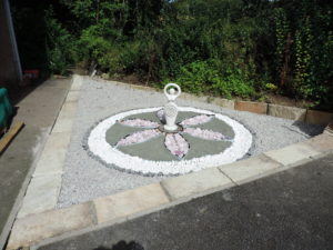 decorative stones area with a sculpture at the centre